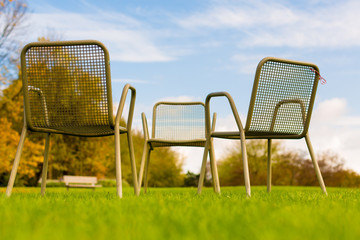 Chair on green grass in park