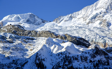 Giant glacier tongue Fee Glacier (Fee Gletscher) are covered with snow creating a beautiful winter landscape in Saas Fee, Switzerland.