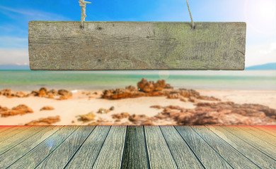 vintage wooden signboard with blank space for insert texts at the beautiful beach.