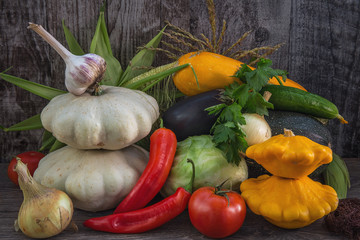 autumn vegetables. a variety of vegetables, lying on dark grey wooden Desk. yellow, white, red and green vegetables. in a rustic style. a lot of vegetables in mounds