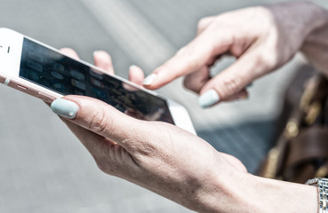 Beautiful female hands working with smartphone