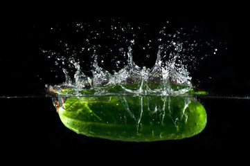 Strawberries splashing into water