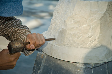 Man with hammer working on stone statue - obrazy, fototapety, plakaty
