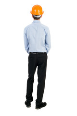 Backview of an engineer in construction helmet stands. Standing young guy. Rear view people collection.  backside view of person.  Isolated over white background. The curly-haired businessman in light