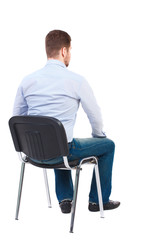 back view of business man sitting on chair.  businessman watching. Rear view people collection.  backside view of person.  Isolated over white background. Bearded businessman in white shirt sits on a