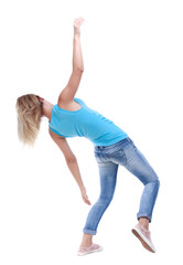 Naklejka premium Balancing young woman. or dodge falling woman. Rear view people collection. backside view of person. Isolated over white background. The blonde in a blue shirt and jeans slipped and falls on his