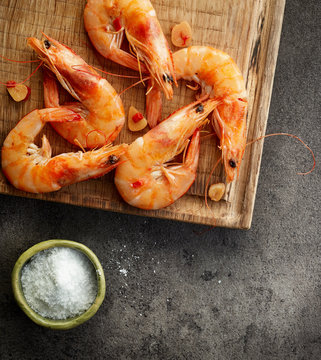 roasted prawns on wooden cutting board