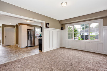 Open floor plan with grey walls and carpet floor