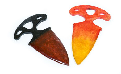 Two wooden models of knives on white background