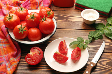 Fresh ripe tomatoes in bowl, half of cutted tomato