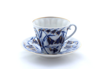 Porcelain cup and saucer on a white background