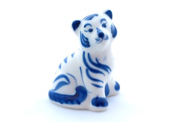 Porcelain figurine of a tiger on white background