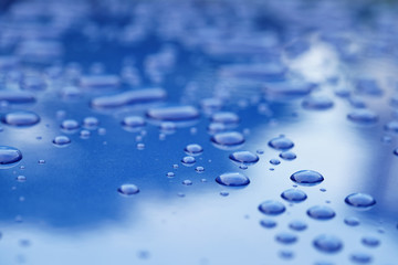 water drops on blue car body threated with protective coating