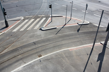 Empty city crossroad with track, pavement and road. Traffic sign with stoplights