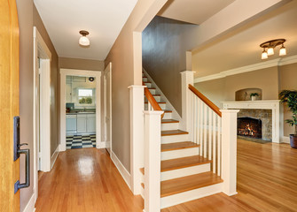 Hallway interior. View of living room with fireplace and kitchen room.