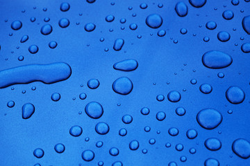water drops on blue car body threated with protective coating