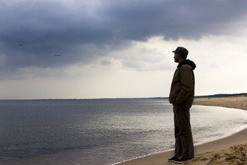 Lonely man looking at sea