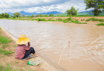 Famer fishing beside river in Northern Thailand