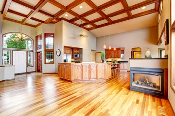 Kitchen and living room with hardwood floor, white entrance door.