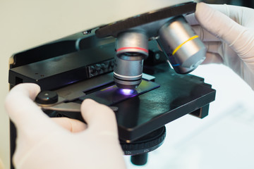 Medical technician using a microscope for checking slide in laboratory : Picture for concept such as hospital, doctor, health and science.