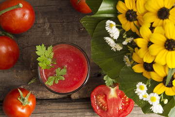 Glass of tomato juice and fresh tomatos