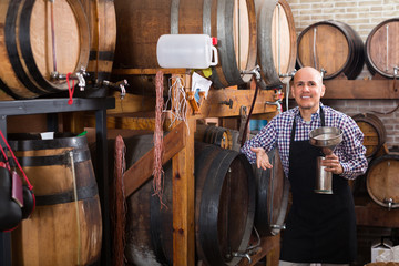 Man with wine in wine house .