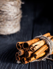 Cinnamon sticks on black wood board