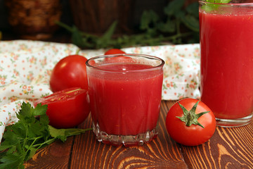 Two glasses of tomato juice and fresh tomatoes