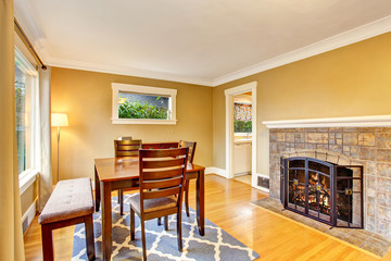 Cozy dining area with wooden table set and fireplace