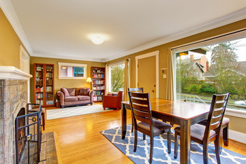 Cozy dining area with fireplace connected to comfortable home library