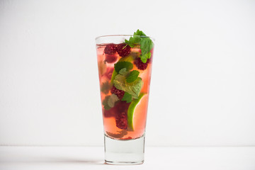 Raspberry cocktail with mint on the wooden background