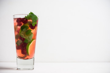 Raspberry cocktail with mint on the wooden background