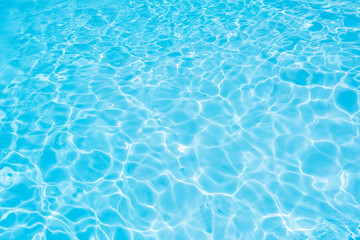 Obraz na płótnie Canvas Blue water surface with sun reflection in swimming pool