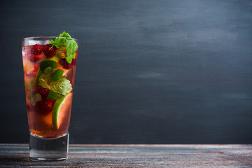 Raspberry cocktail with mint on the wooden background