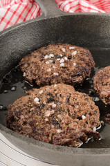 premium angus burger in a cast iron pan