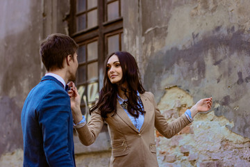 Woman with dark hair looks at a man while dancing with him on an