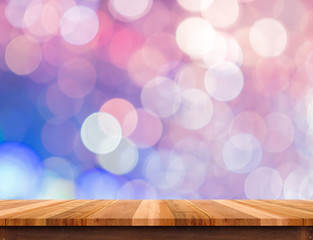 Empty brown wood table top with abstract pink,puple pastel bokeh