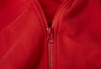 A full page of bright red fleece fabric texture with a half undone zip