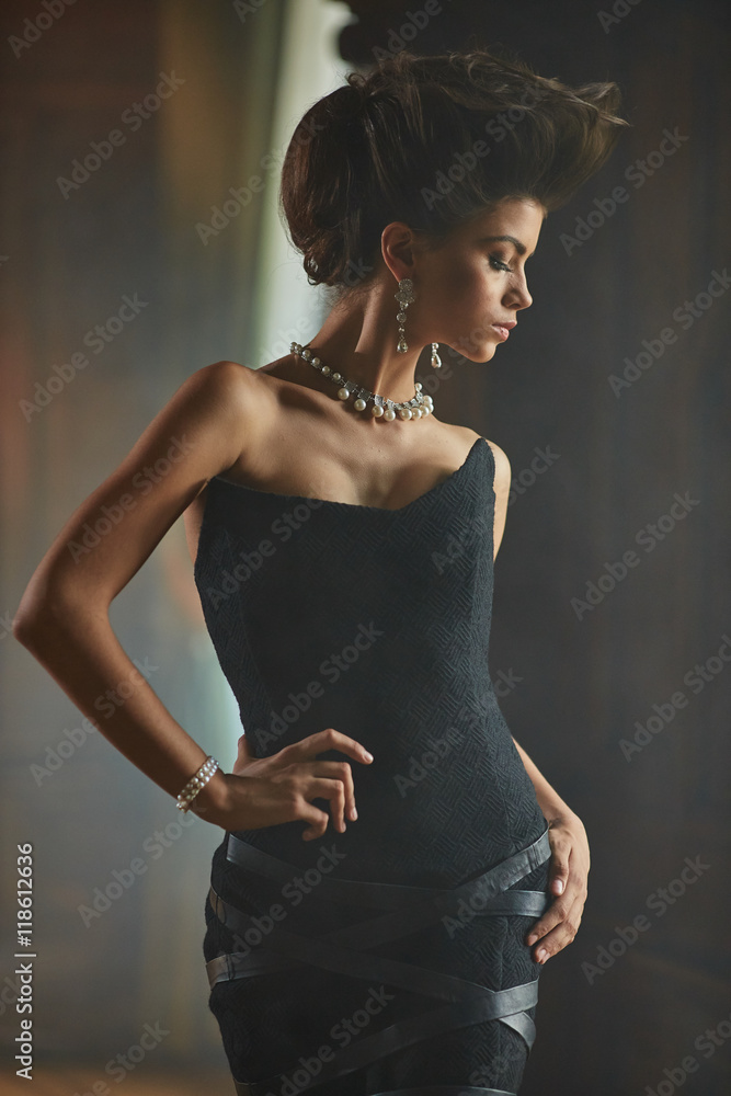 Wall mural graceful model walks through the whit smoke in dark room