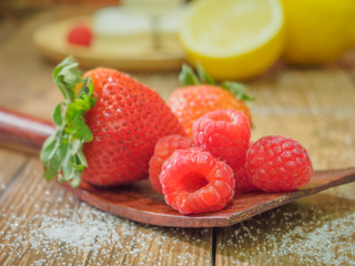 strawberries and raspberries in bowls, top view, close-up Select