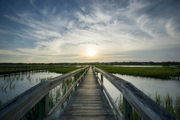 Fototapeta na wymiar boardwalk in the marsh at sunset, Pawleys Island, South Carolina