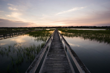 Fototapeta na wymiar boardwalk in the marsh at sunset, Pawleys Island, South Carolina