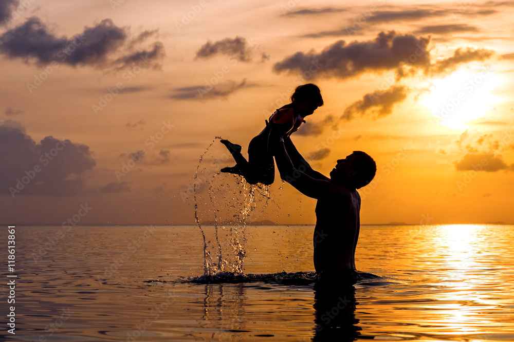 Wall mural the man in the sea holding a little girl in her arms