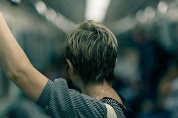woman with short haircut in metro is back