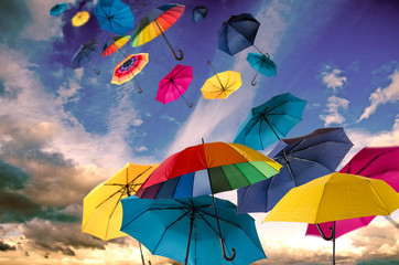 Happiness, lust for life: flying colorful umbrellas on in front of blue sky :)