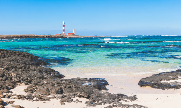 Seaside view in Fuerteventura with clear water and lighthouse
