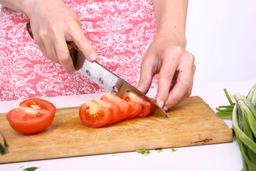 Healthy food concept. Cutting vegetables into a salad.