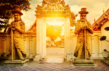 Classical Thai architecture in public temple at dramatic orange sunset sky, Bangkok, Thailand....