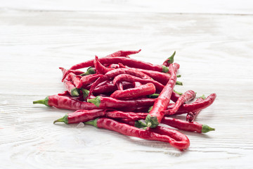 Red paprika with chilli peppers on wooden background