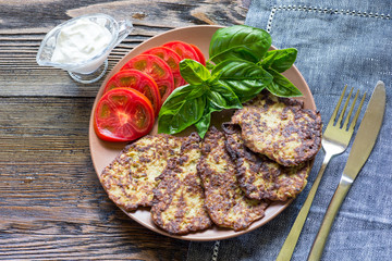 Vegetable cutlets with tomato and basil on a plate
